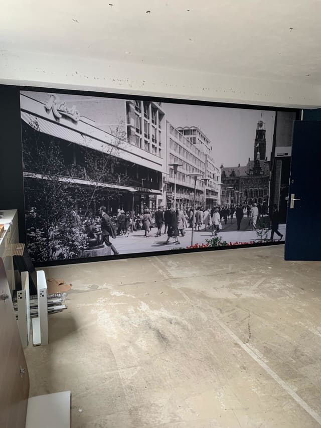 Smartframe over een hele wand met een zwart-witte foto van een drukke winkelstraat